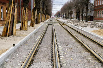 Street reconstruction, tree trunks with board protectors, newly replaced tram tracks and pavement