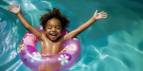 A happy African American boy floats in a pool with an inflatable ring, raising his arms in joy, enjoying the first day of summer vacation in the water.