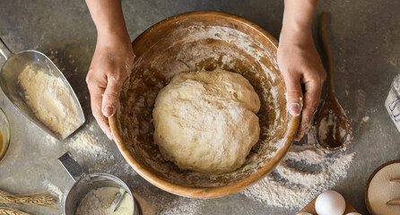 Fototapeta premium Female chef preparing dough on kitchen table, closeup