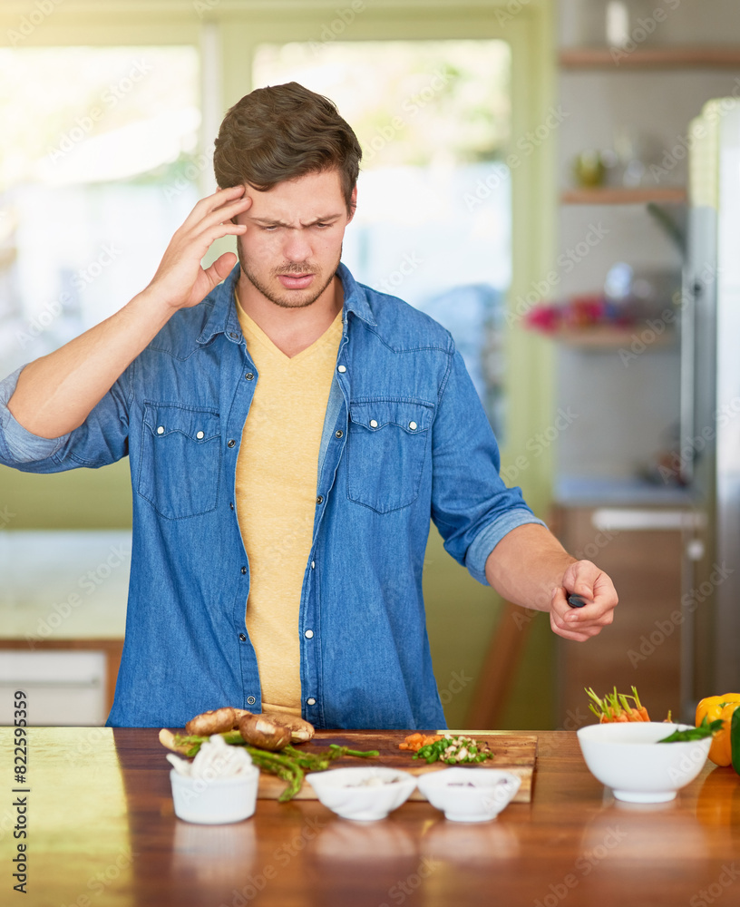 Poster Cooking, confused and man with healthy food for nutrition, meal prep and cutting fresh ingredients for lunch. Diet, vegetables and home chef at kitchen counter with knife, recipe and salad for dinner