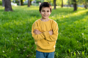Portrait of little adorable smiling boy on spring sunny day in park