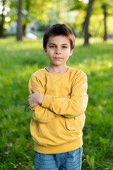 Portrait of little adorable smiling boy on spring sunny day in park