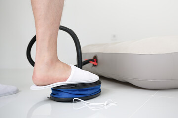 pumping inflating mattress on white ceramic floor