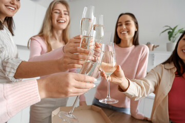 Young women drinking champagne at Hen Party in kitchen, closeup