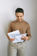 Successful employee businessman hold paper documents look camera