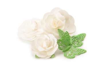 Flowers made of fabric and green plastic butterflies on white background