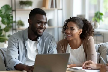 Couple sitting couch laptop living room