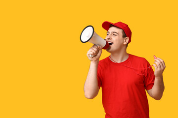 Male lifeguard with megaphone and whistle on yellow background