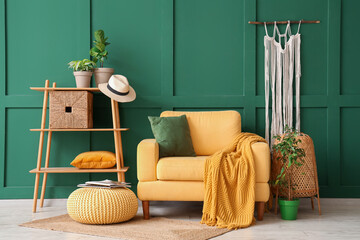 Interior of stylish living room with yellow armchair, pouf and shelf unit