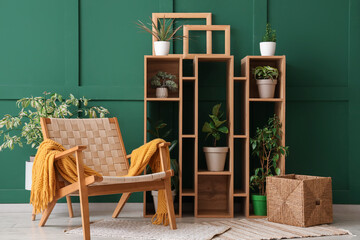 Interior of stylish living room with wooden armchair, shelf unit and plants