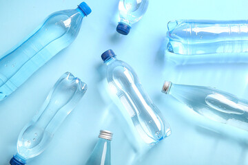 Bottles of clean water on blue background