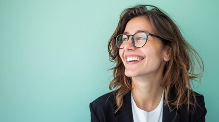 Young happy cheerful professional business woman, happy laughing female office worker wearing glasses looking away, light green background, 16:9