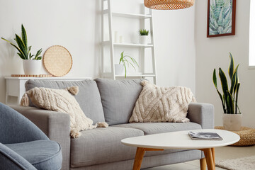 Interior of living room with cozy grey sofa and coffee table