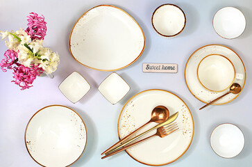 Cutlery with flowers on a plate on a marble background. Elegant festive table setting, menu layout...