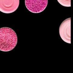  a black background with six circles containing pink and purple bath salts.