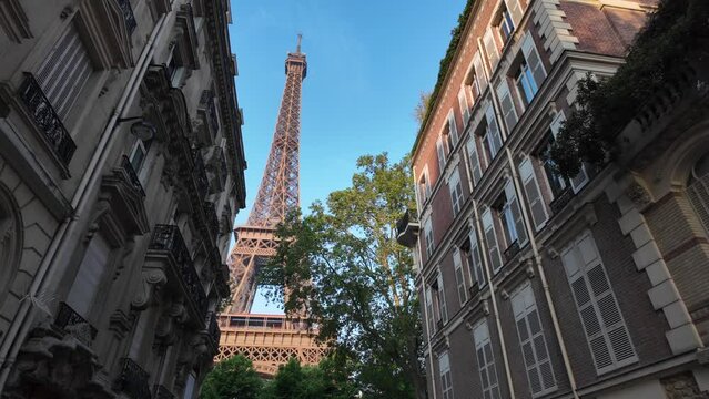 Image of Paris and the Eiffel Tower between buildings, unique point of view, city architecture. Capital of the 2024 Olympics. Paris 2024 Olympic Games.