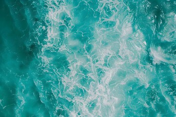 Top view of turquoise sea water texture with waves and splashes