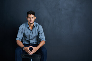 Businessman, dark background and confidence in portrait on chair with mockup space for worker in...