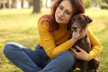 Woman with her cute German Shorthaired Pointer dog in park on spring day