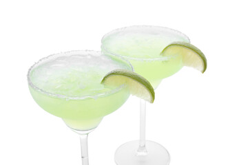 Delicious Margarita cocktail with ice cubes in glasses, salt and lime isolated on white