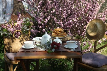Beautiful spring flowers, freshly baked waffles and ripe strawberries on table served for tea...