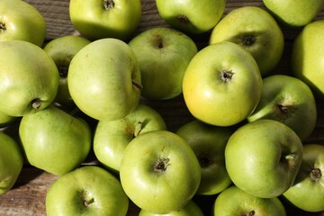 Many fresh apples on wooden table, top view