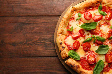 Delicious Margherita pizza on wooden table, top view. Space for text