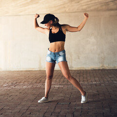 Girl, energy and happy dancer in city with dancing for practice, routine and rehearsal with streetwear. Fitness, artist and person with wellness for movement with smile, passion and skill for hip hop