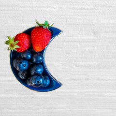 strawberries and blueberries in a bowl