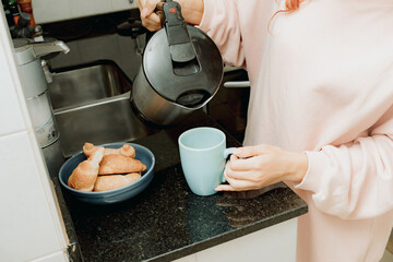 Young woman make coffee in the kitchen