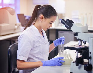 Woman, scientist and test tube for study in laboratory, microscope and working for medical research...