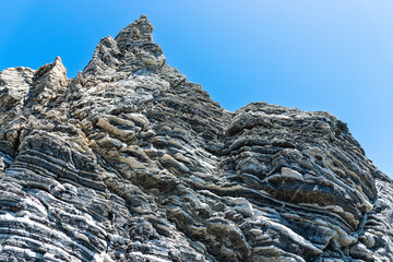 Nature force compressed prominent cracked rock layers structure formation details, in various...