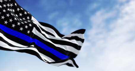 The american flag in the Thin Blue Line variant waving in the wind