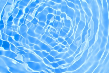 Blue rippled water surface. Sun reflection on blue water wave texture. Transparent clear water with...