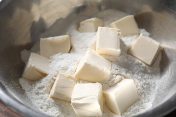 Making shortcrust pastry. Flour and butter in bowl, closeup