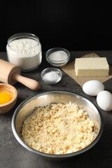Making shortcrust pastry. Different ingredients for dough and rolling pin on grey table