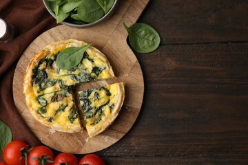 Delicious pie with spinach on wooden table, flat lay. Space for text
