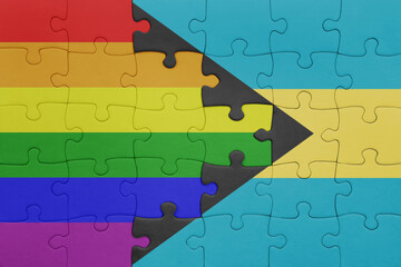 puzzle with the colourful national flag of bahamas and rainbow gay pride flag .