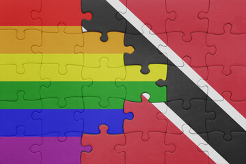puzzle with the colourful national flag of trinidad and tobago and rainbow gay pride flag .