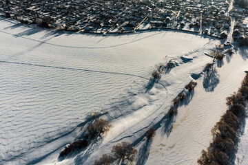 Obraz premium Gray landscape of snowy countryside from the air