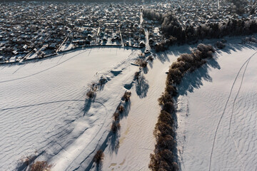 Gray landscape of snowy countryside from the air