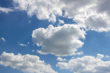 Cumulus clouds in the blue sky.