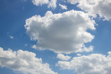 Cumulus clouds in the blue sky.