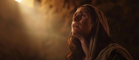 Fototapeta premium Biblical character. Emotional close up portrait of a woman with blue eyes in a veil looking up. Looking up to heaven with tears in her eyes, full-length shot set in biblical times,