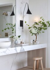 A simple modern bathroom with an oversized white marble vanity and wall mirrors featuring natural stone floors,