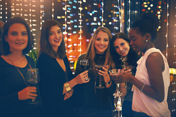 Friends, women and cocktail party with toast for portrait at nightclub, event and happy hour. Diverse group, club and drink with alcohol and smile with celebration for new year with cheers in night