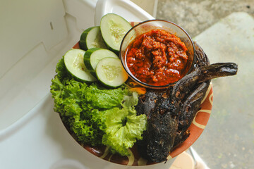 Lele goreng or Fried Catfish is a traditional Indonesian culinary food. Lele tomato and chili paste, popular street snack named Pecel Lele Lamongan.