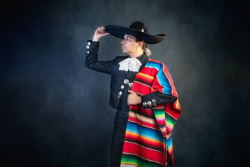 Mexican Charro A man in a sombrero and a colorful blanket