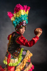 Matlachines Dancer from Coahuila Mexico A man in a colorful costume is holding a drum