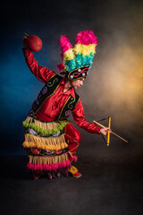 Matlachines Dancer from Coahuila Mexico A man in a colorful costume is holding a ball and a stick